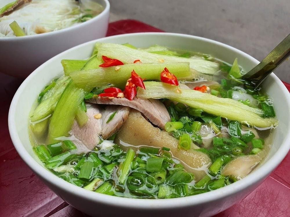 Clear noodle soup with translucent porkballs in light broth